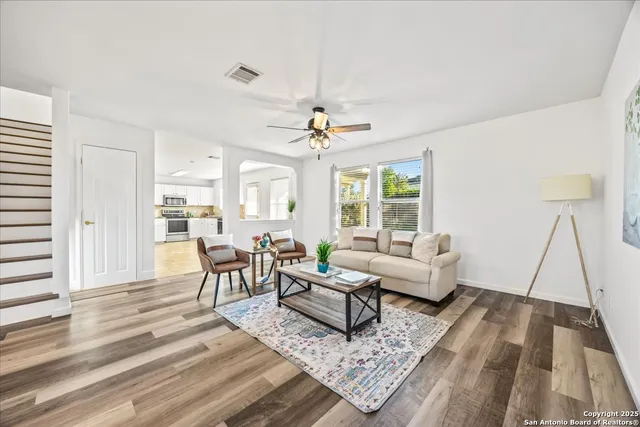 a living room with furniture and a chandelier