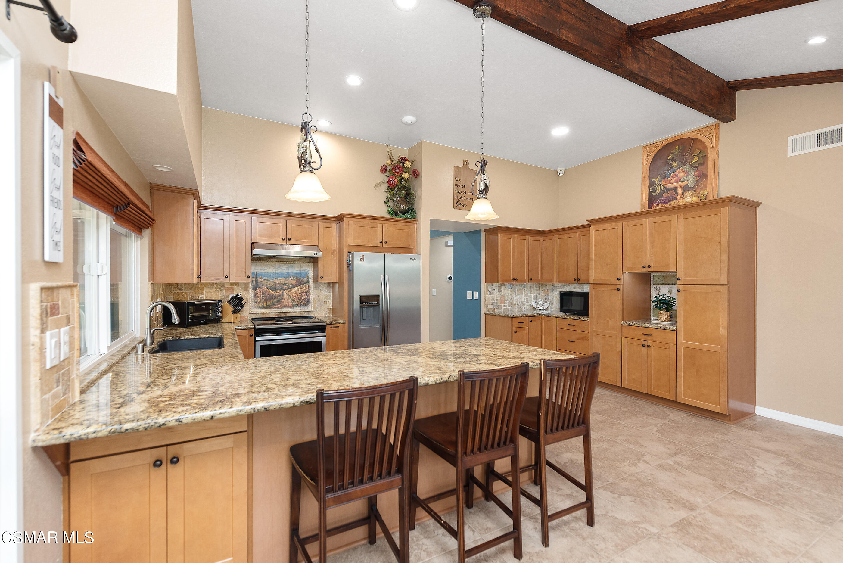 852 Weaver Street Simi Valley, CA 93065 - Photo 24 of 45 a kitchen with stainless steel appliances granite countertop a kitchen island a stove a table and chairs