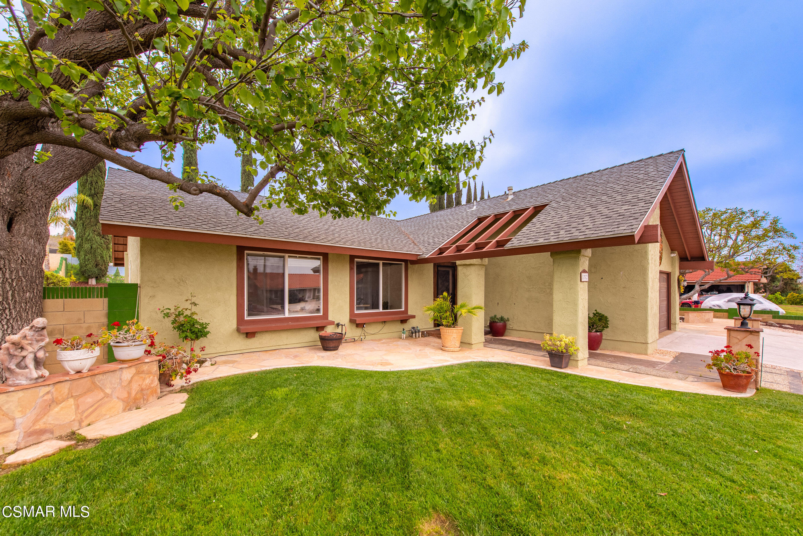 852 Weaver Street Simi Valley, CA 93065 - Photo 6 of 45 a front view of a house with a garden and sitting area