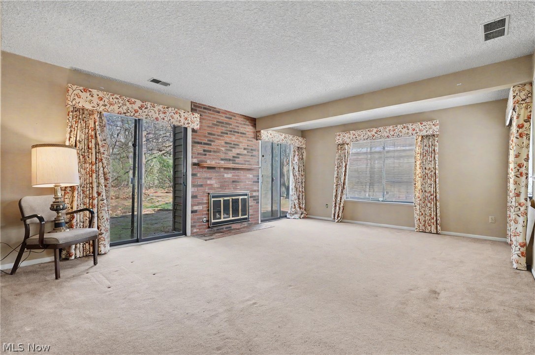 624 Hampton Ridge Drive Akron, OH 44313 - Photo 16 of 46 Another view of the family room with fireplace and two sets of sliders to the brick patio.