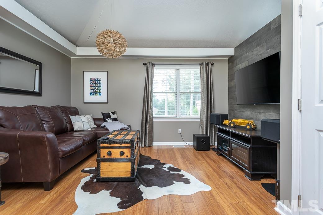 3306 Mill Run, Unit 3306 Raleigh, NC 27612 - Photo 11 of 24 a living room with furniture and a flat screen tv