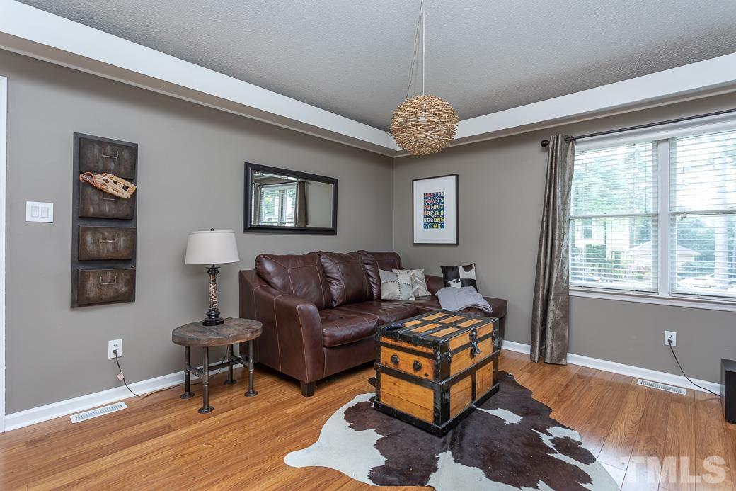3306 Mill Run, Unit 3306 Raleigh, NC 27612 - Photo 12 of 24 a living room with furniture a chandelier and a window