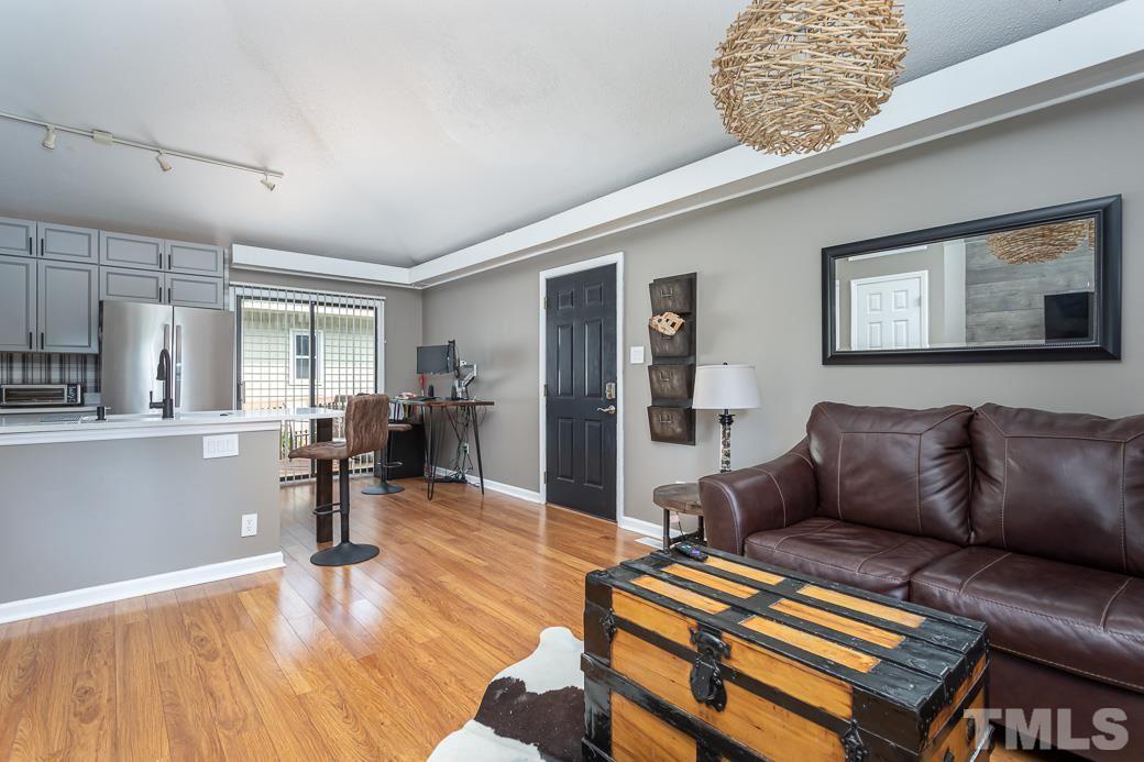 3306 Mill Run, Unit 3306 Raleigh, NC 27612 - Photo 13 of 24 a living room with furniture and a wooden floor