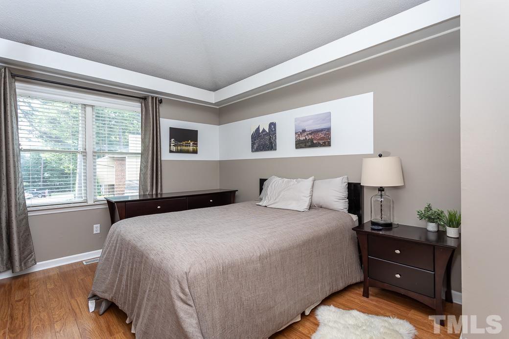 3306 Mill Run, Unit 3306 Raleigh, NC 27612 - Photo 18 of 24 a bedroom with a bed and a window