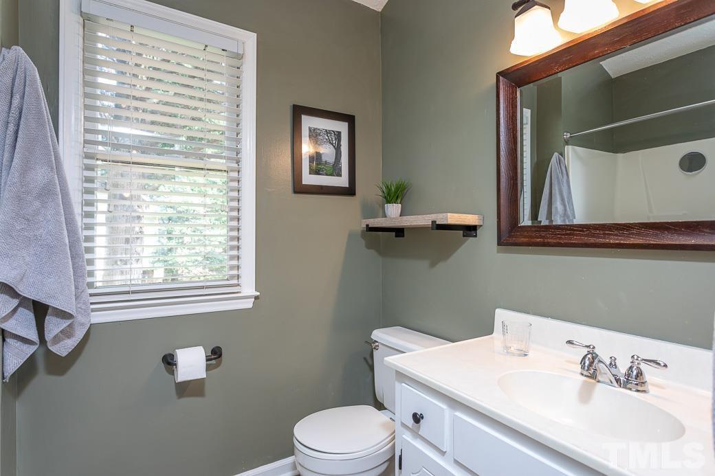 3306 Mill Run, Unit 3306 Raleigh, NC 27612 - Photo 21 of 24 a white toilet sitting next to a bathroom sink
