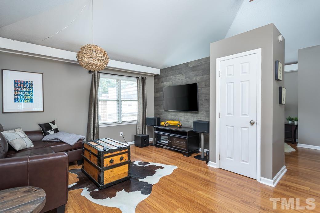 3306 Mill Run, Unit 3306 Raleigh, NC 27612 - Photo 9 of 24 a living room with furniture and a flat screen tv