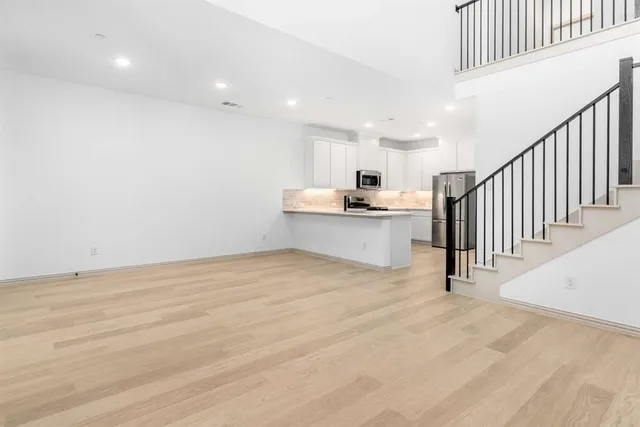 a view of a kitchen with wooden floor and electronic appliances