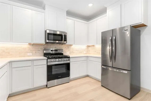 a kitchen with a refrigerator stove and microwave