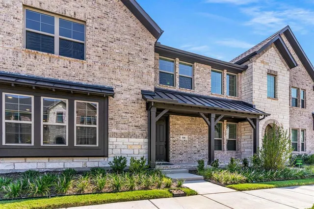 a front view of a house with plants