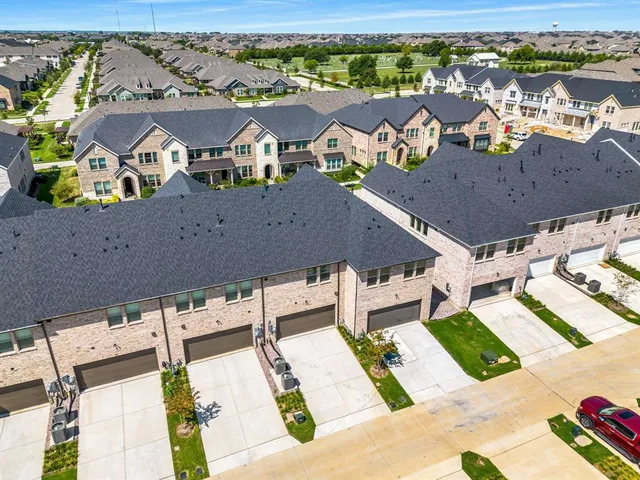 an aerial view of residential houses with outdoor space