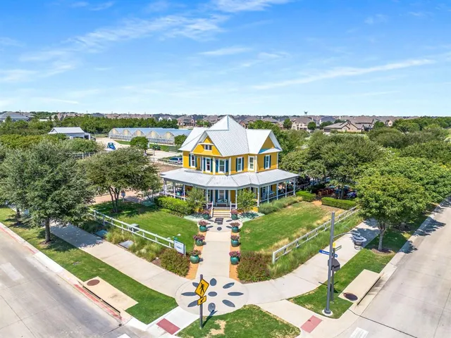 a view of a house with a yard and lake view