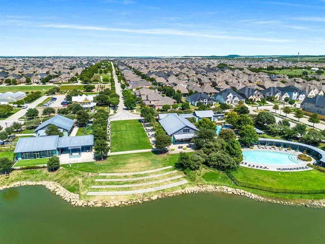 a view of residential houses with outdoor space and swimming pool