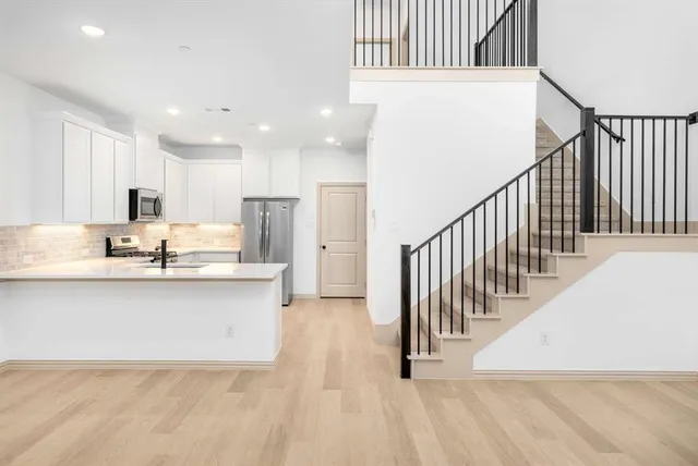 a view of kitchen with wooden floor and electronic appliances