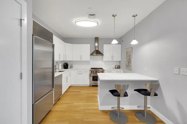 a kitchen with kitchen island a counter top space appliances and cabinets