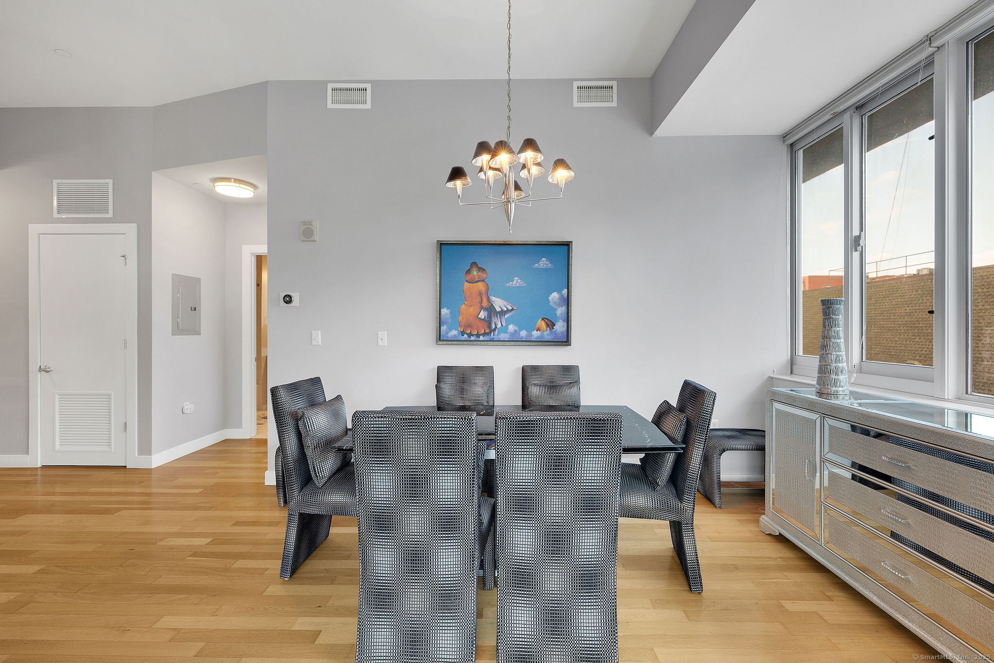 1515 Summer Street, Unit 302 Stamford, CT 06905 - Photo 11 of 33 a living room with furniture dining table and a floor to ceiling window