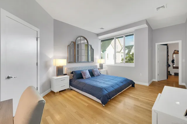 a bedroom with a bed and a view of living room