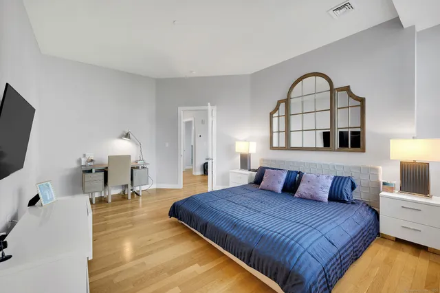 walk in closet with wooden floor