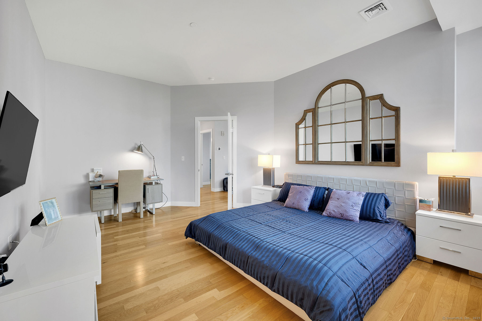 1515 Summer Street, Unit 302 Stamford, CT 06905 - Photo 13 of 33 a bedroom with a bed and a view of living room