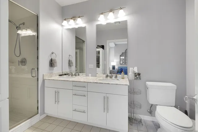 a bathroom with a granite countertop shower sink and mirror