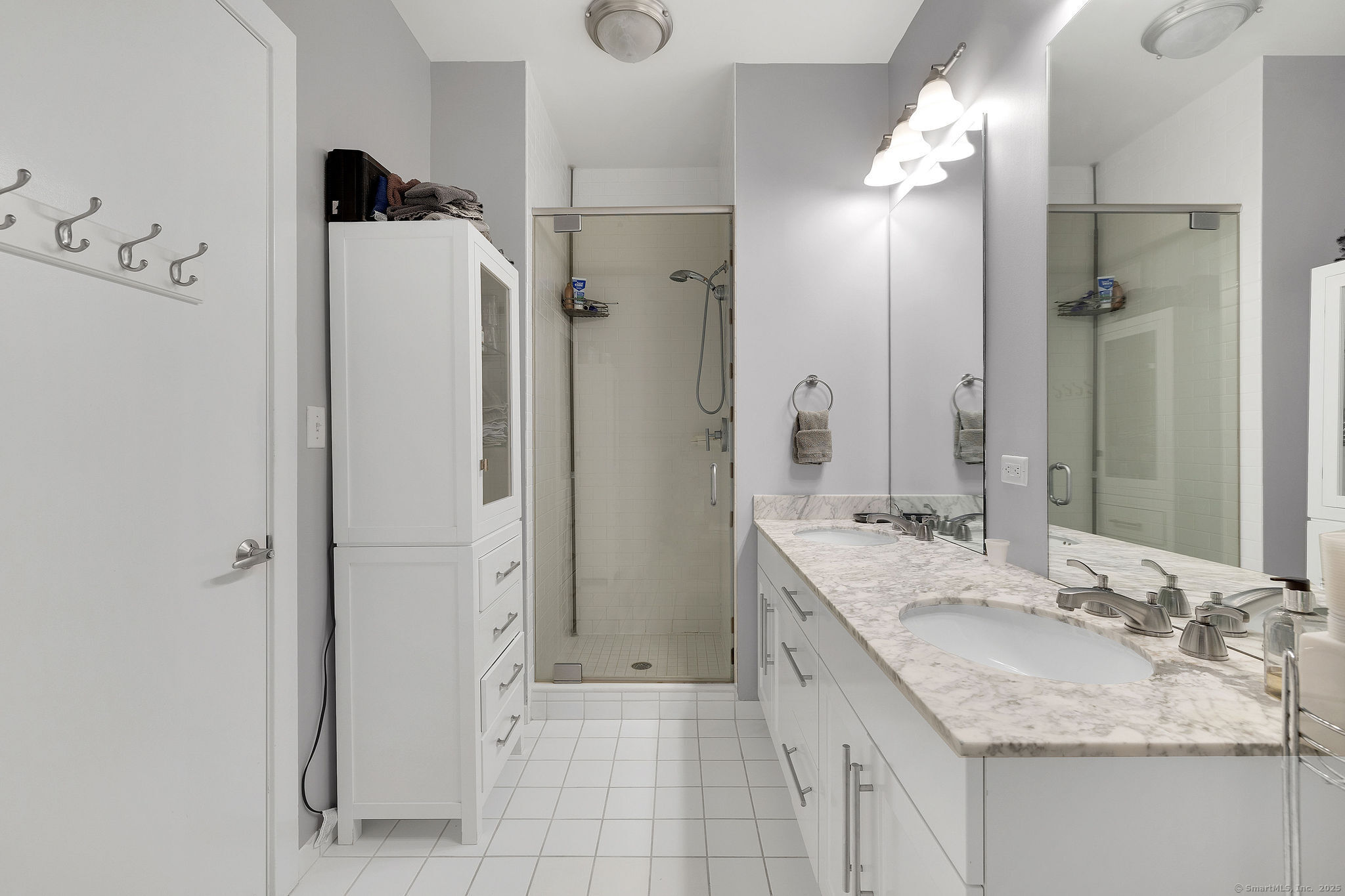 1515 Summer Street, Unit 302 Stamford, CT 06905 - Photo 16 of 33 a bathroom with a granite countertop shower sink and mirror
