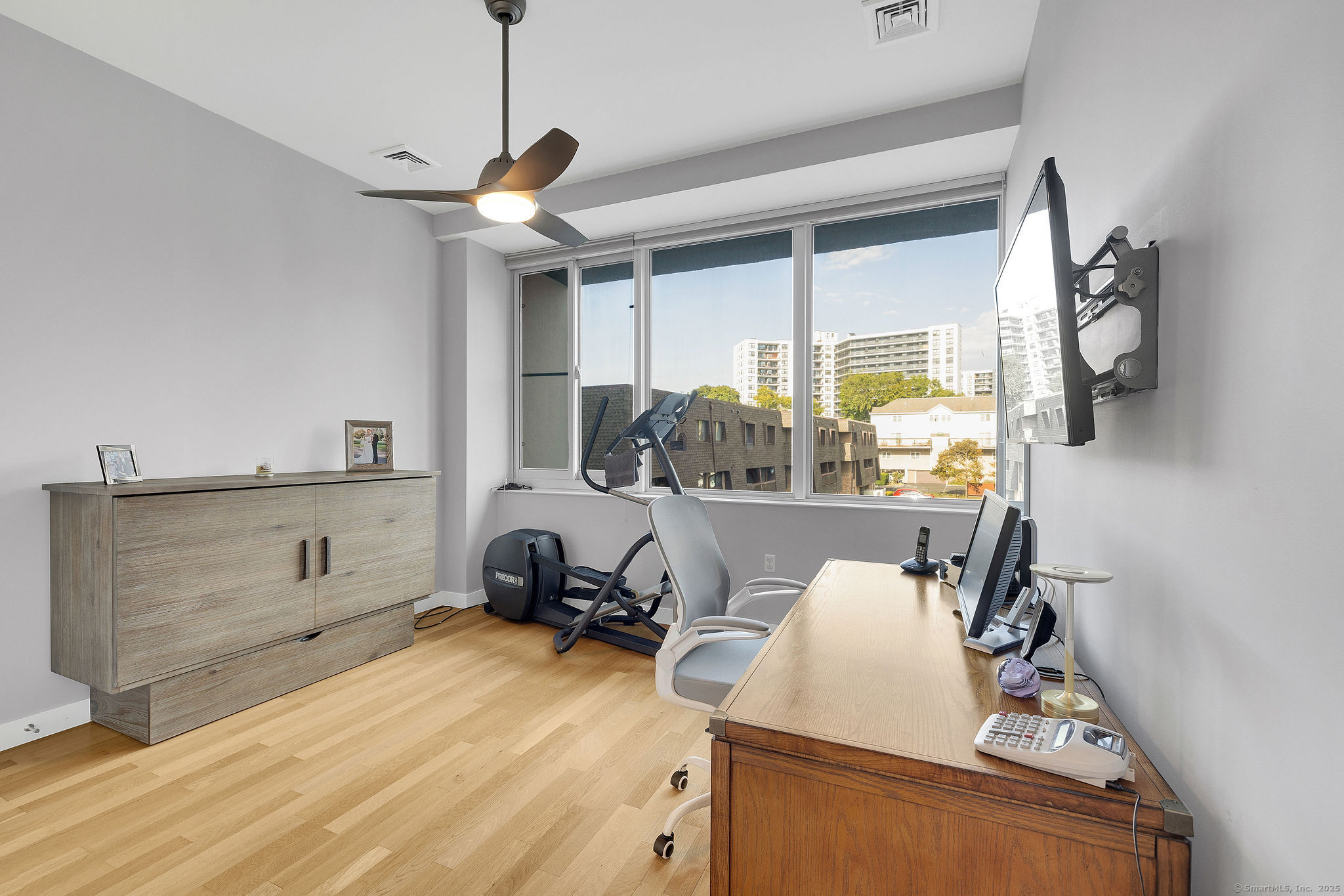 1515 Summer Street, Unit 302 Stamford, CT 06905 - Photo 20 of 33 a room with a bed and cabinets