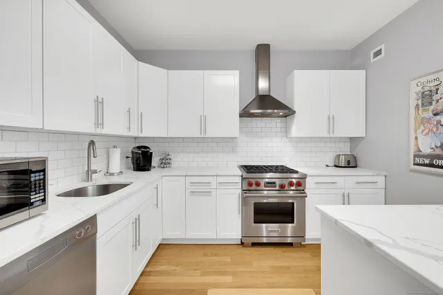 a kitchen with a stove a sink and a refrigerator