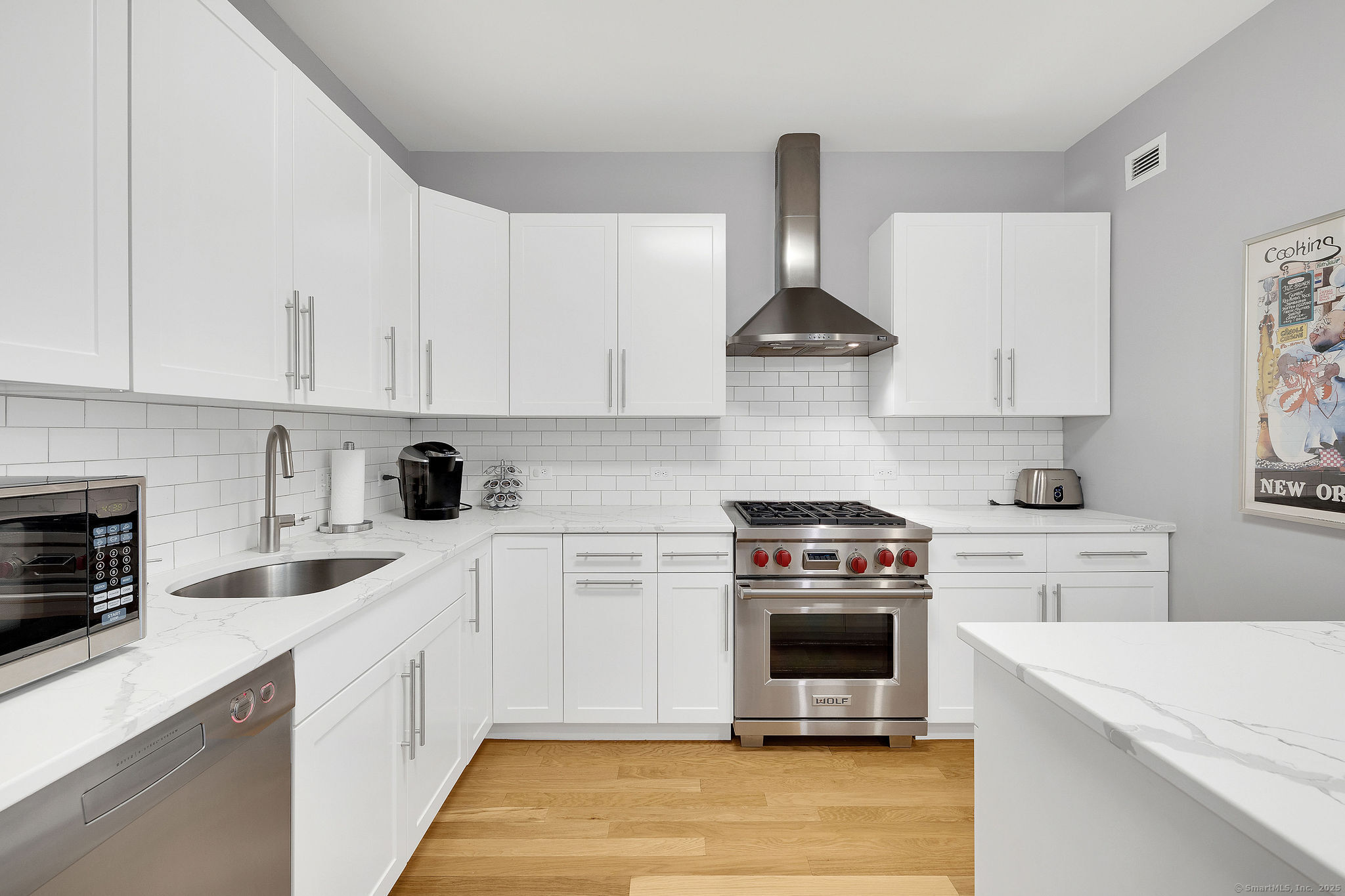 1515 Summer Street, Unit 302 Stamford, CT 06905 - Photo 2 of 33 a kitchen with a stove a sink and a refrigerator