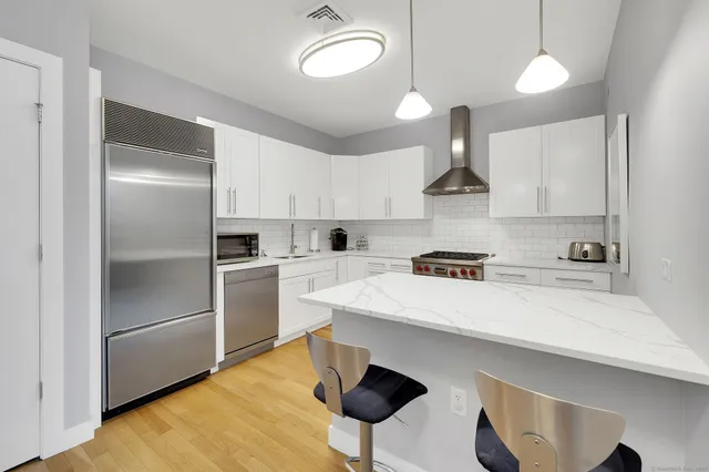 a kitchen with cabinets and stainless steel appliances