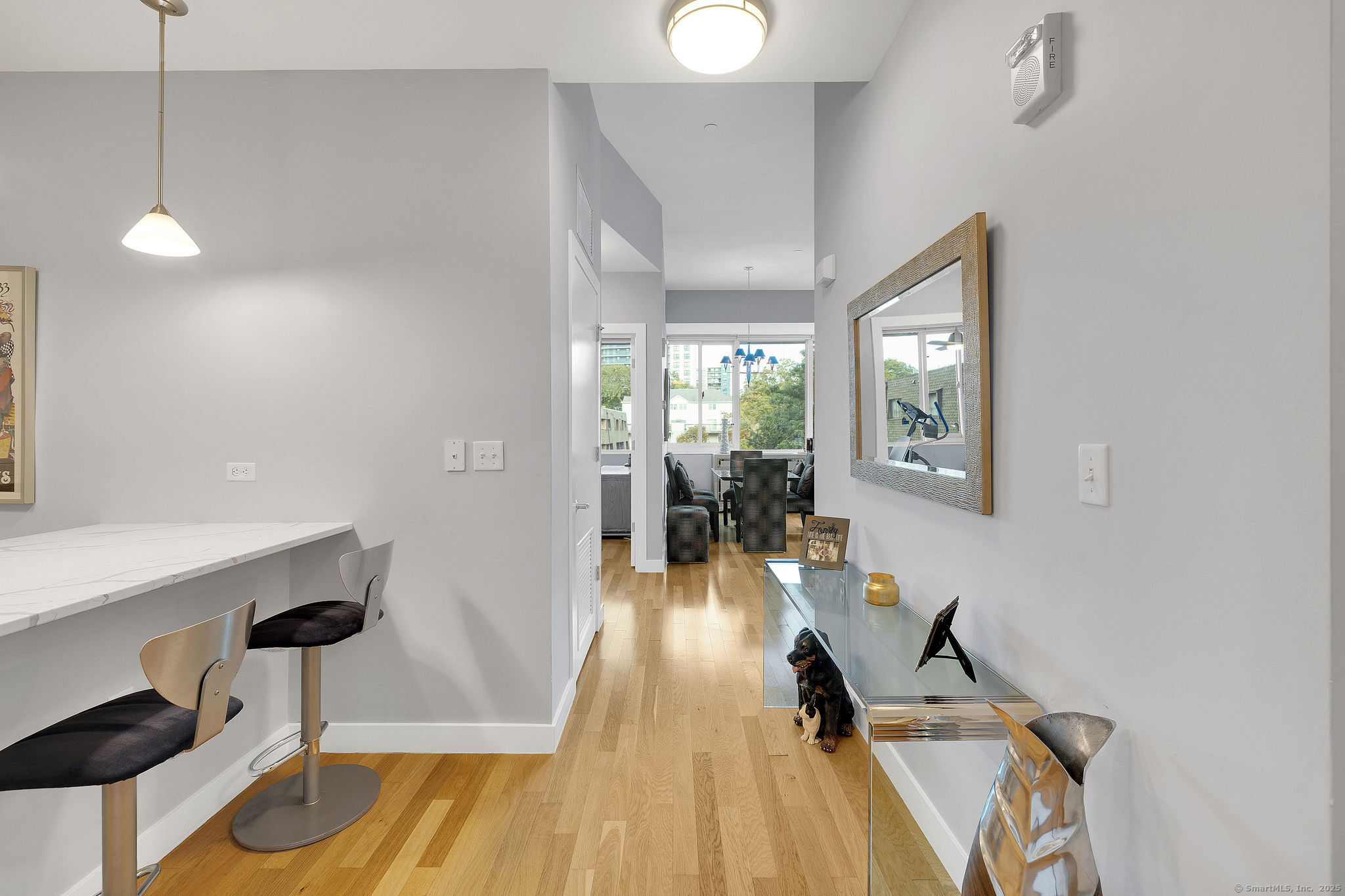 1515 Summer Street, Unit 302 Stamford, CT 06905 - Photo 5 of 33 a view of a room with furniture and wooden floor