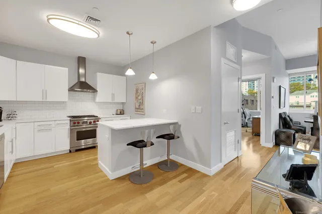 a living room with fireplace furniture and a large window