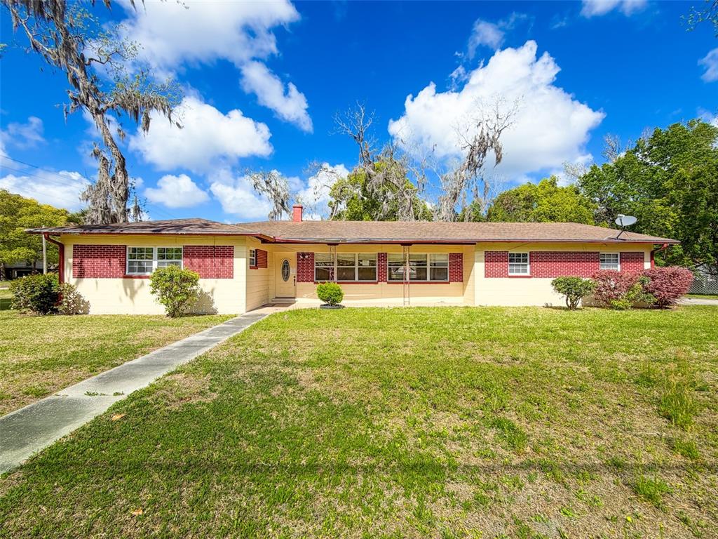 615 North Church Street Starke, FL 32091 - Photo 1 of 44 a front view of a house with a garden