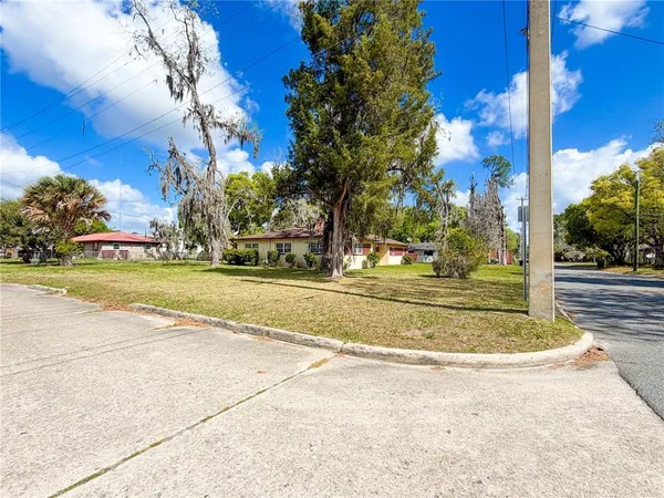 a view of fountain with large trees