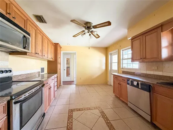 a kitchen with stainless steel appliances granite countertop a sink and cabinets