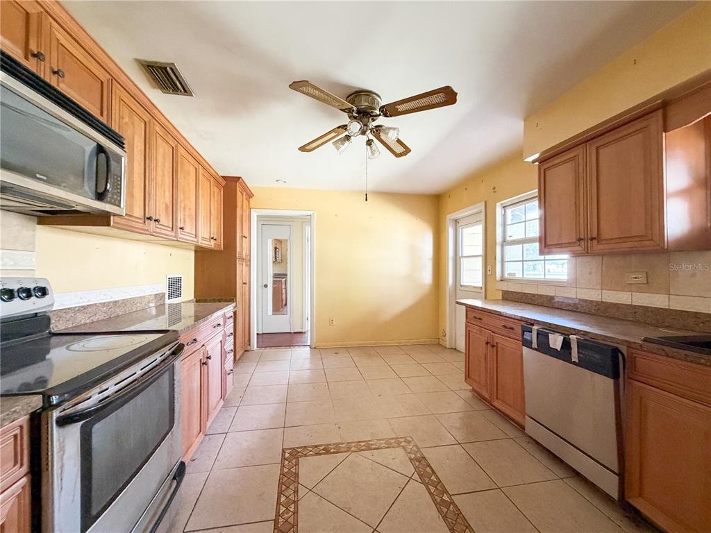 615 North Church Street Starke, FL 32091 - Photo 22 of 44 a kitchen with stainless steel appliances granite countertop a sink and cabinets