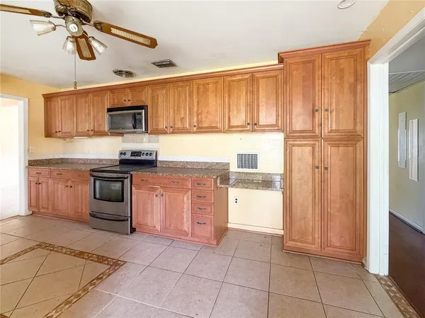 a kitchen with a stove a sink and a refrigerator