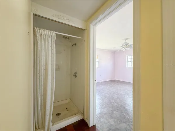a view of a bathroom with a glass shower door