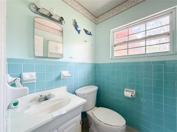 a bathroom with a sink a mirror and a toilet