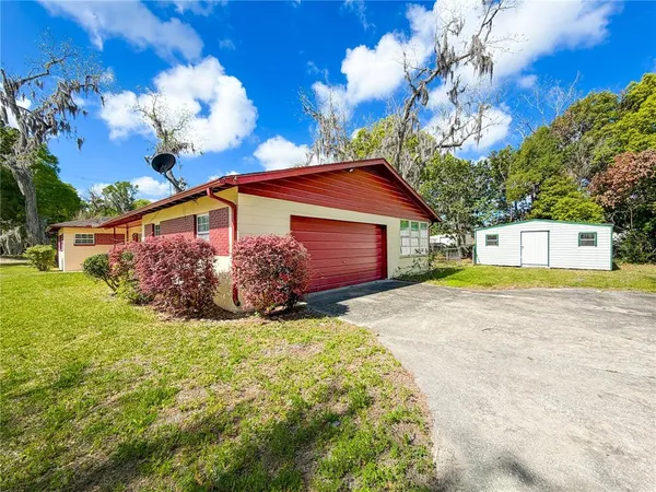 a front view of a house with a yard and fountain