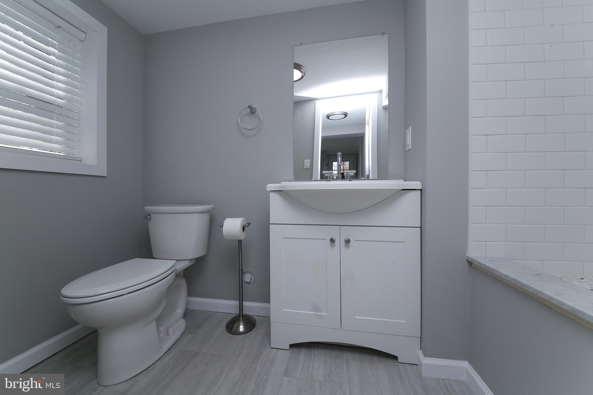 986 Coronet Road Warminster, PA 18974 - Photo 13 of 17 a bathroom with a toilet sink and mirror