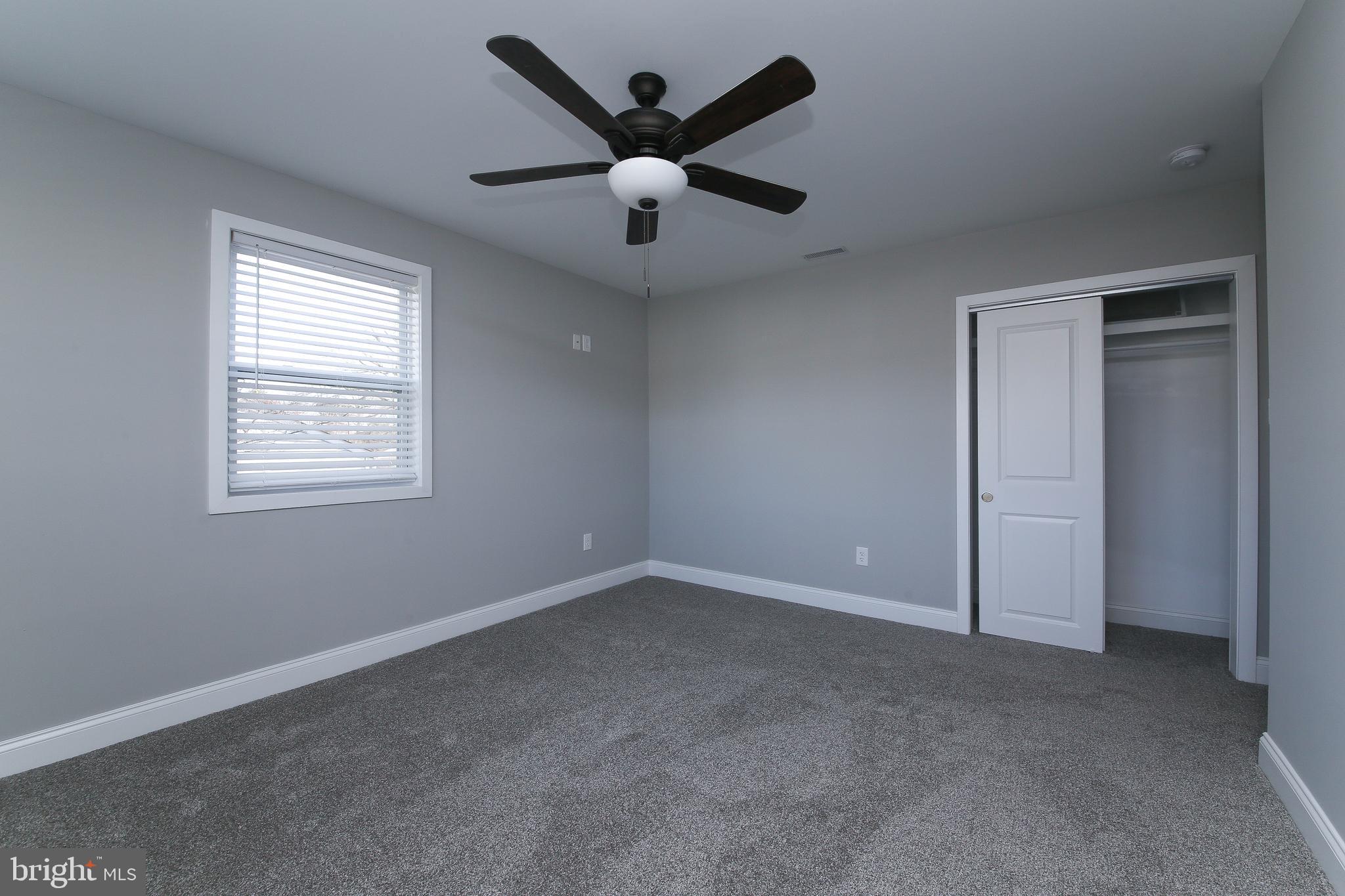 986 Coronet Road Warminster, PA 18974 - Photo 5 of 17 an empty room with ceiling fan and windows