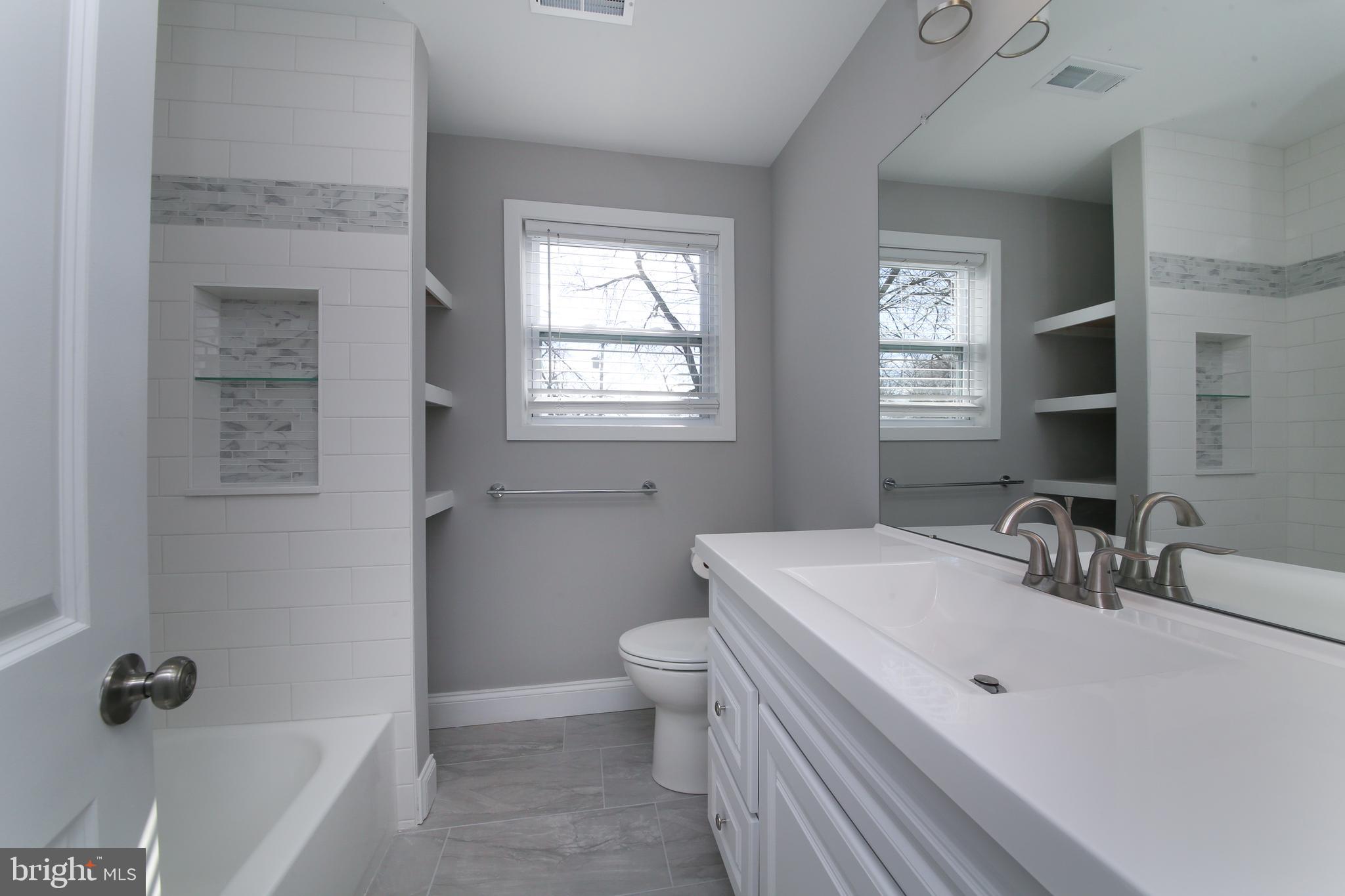 986 Coronet Road Warminster, PA 18974 - Photo 7 of 17 a bathroom with a sink a toilet and shower