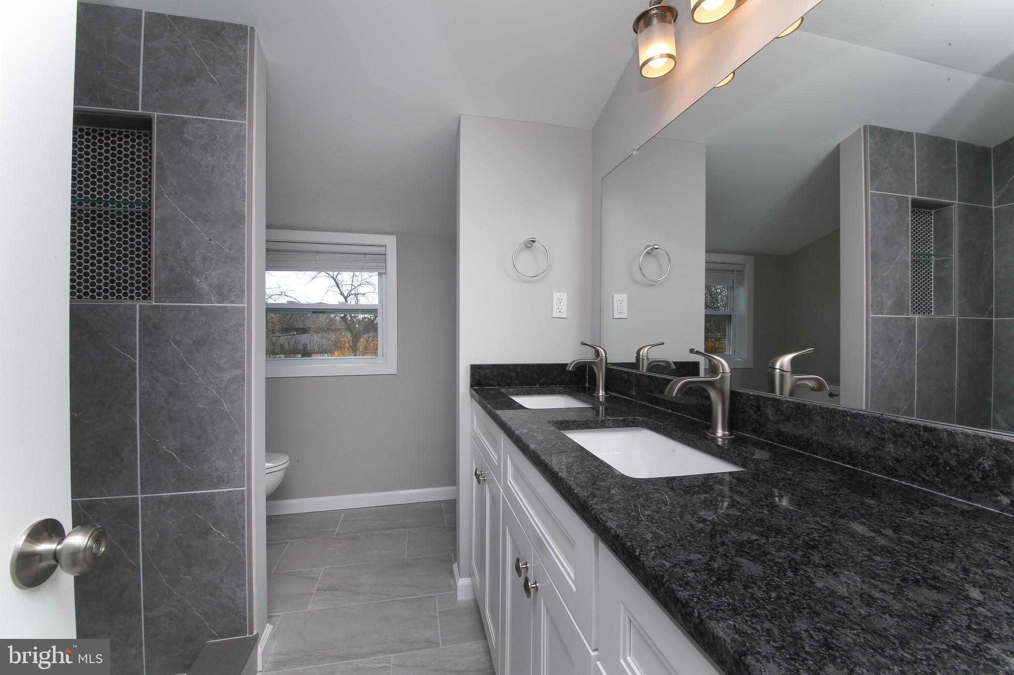 986 Coronet Road Warminster, PA 18974 - Photo 10 of 17 a bathroom with a granite countertop sink a mirror and shower