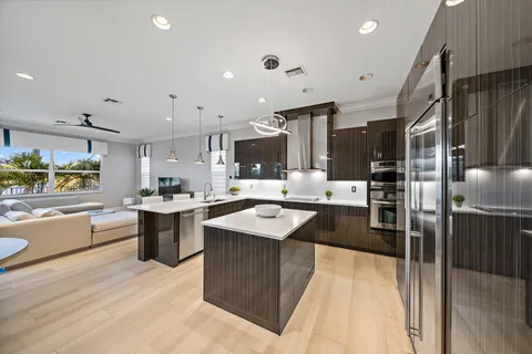 a kitchen with stainless steel appliances a sink a counter top space and cabinets