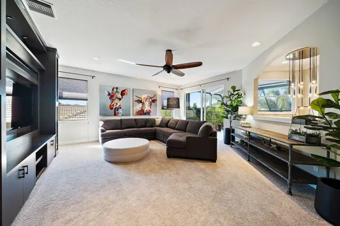 a spacious bedroom with a bed and a chandelier