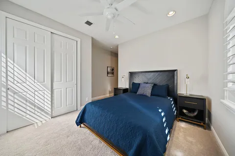 a bedroom with a large bed and a chandelier