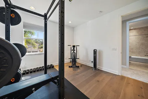 a spacious bedroom with a bed a couch and a window