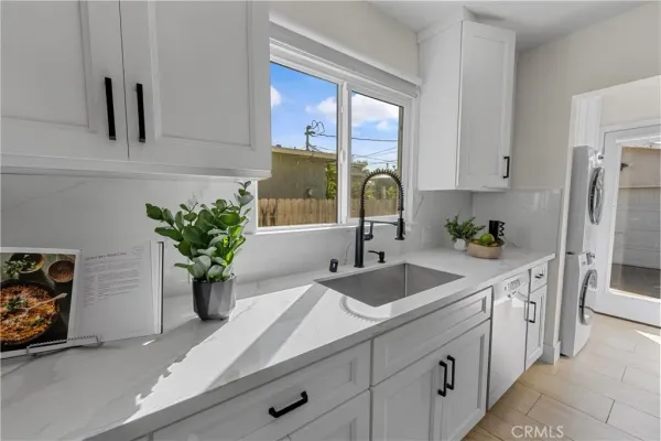 a kitchen with stainless steel appliances sink and white cabinets