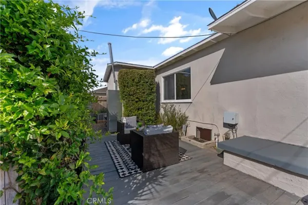 a view of a patio with table and chairs and potted plants