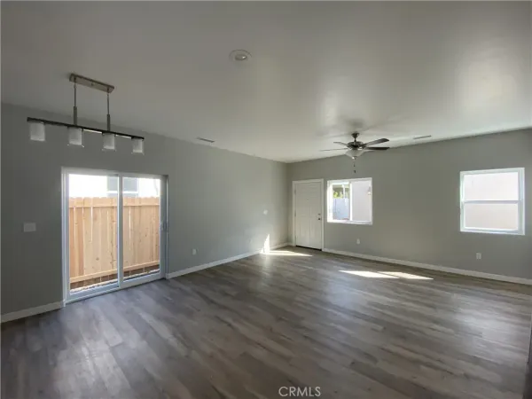 a view of a kitchen with a sink and wooden floor