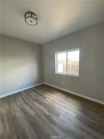 a view of a patio with a table and chairs under an umbrella